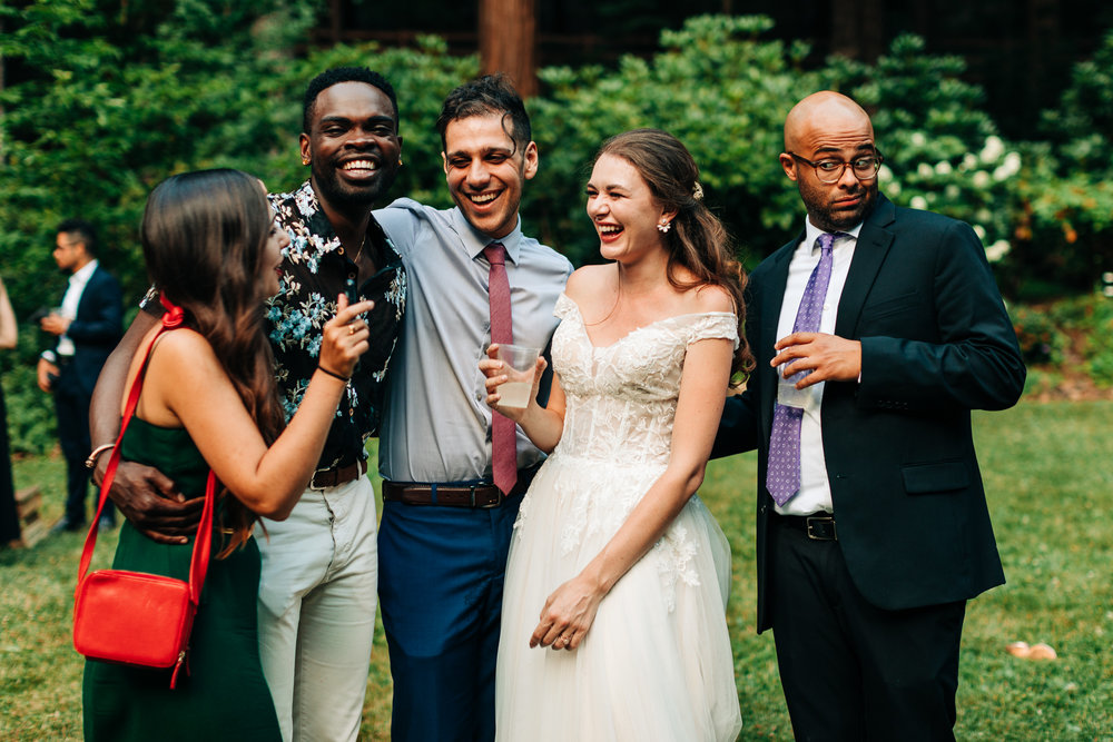 bride with friends laughing during a conversation