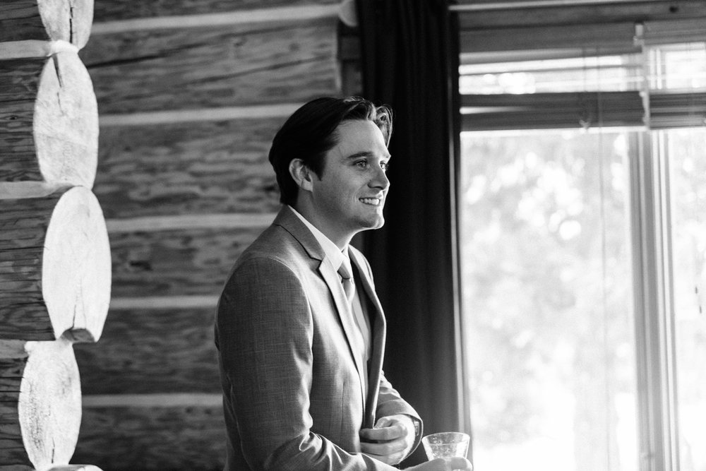 Black and white candid portrait of groom