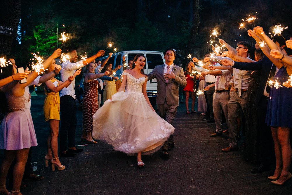 couple waving while leaving sparkler exit