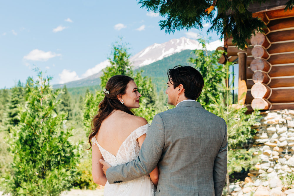 Wedding portrait of bride and groom having a moment by Mount Shasta