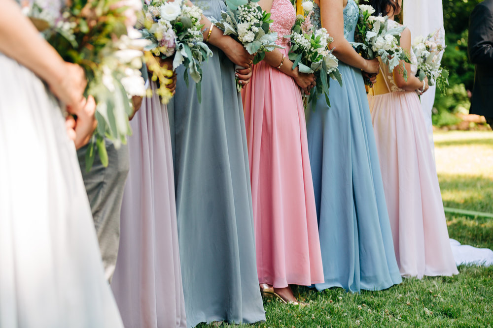 purple, pink, and blue pastel bridesmaid dresses and bouquets
