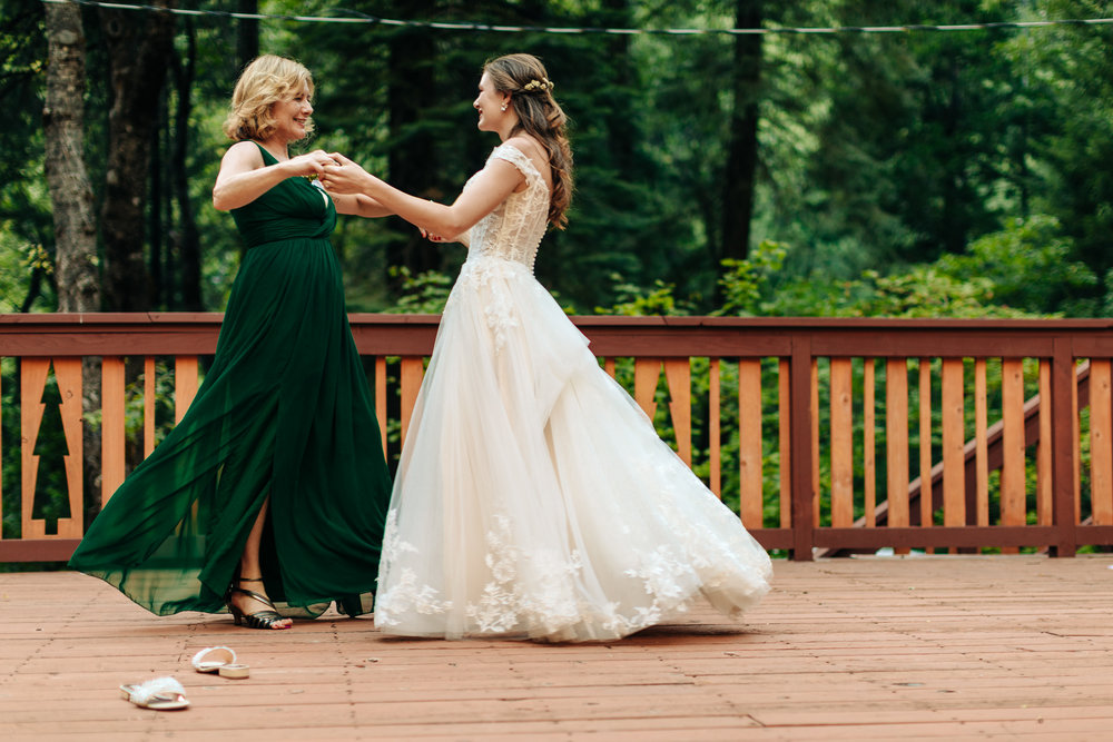 bride and mother during a surprise mother-daughter dance with badgley mischka slides