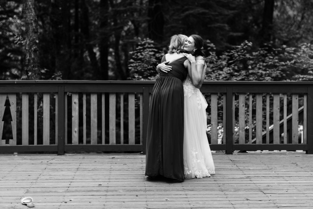 bride hugging her mother after a surprise mother-daughter dance
