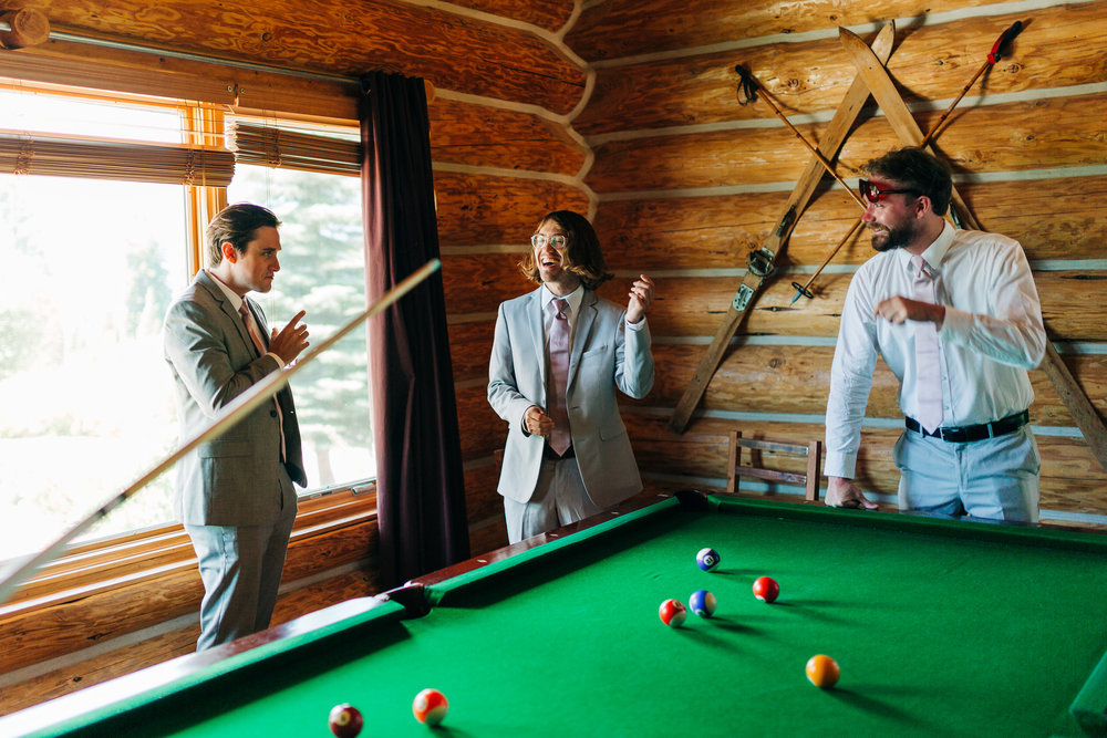 Groomsmen playing pool on wedding morning