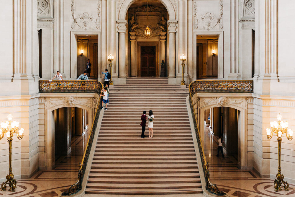 Couple looking back at tourists on the grand staircase