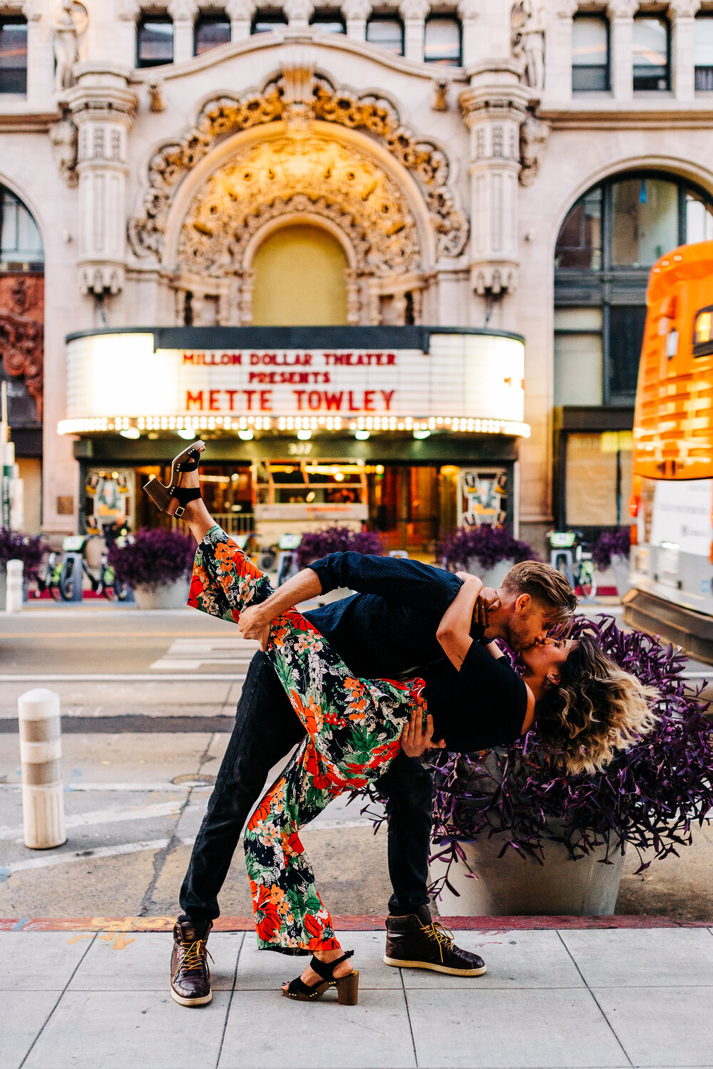 cinematic shot of couple in front of million dollar theater