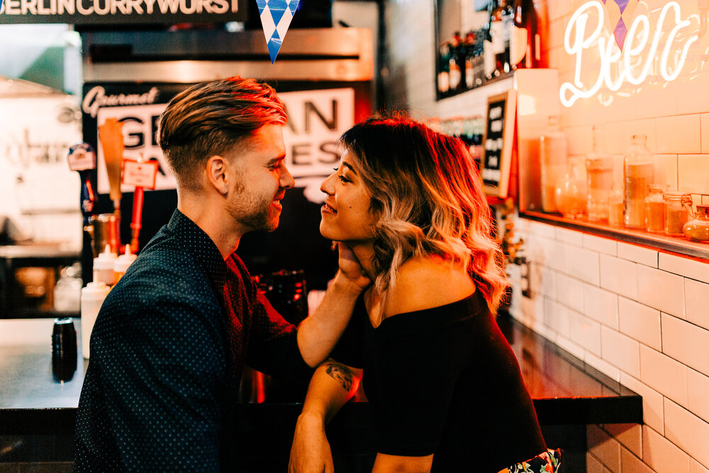 couple on a date under neon sign