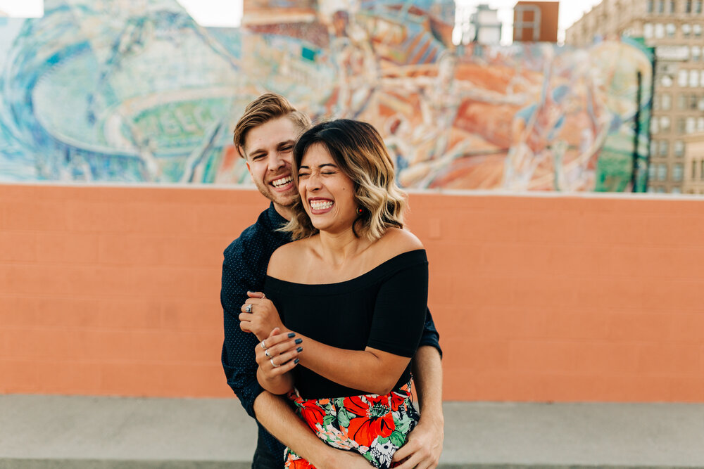 Fun engagement photography of couple being playful in downtoan los angeles