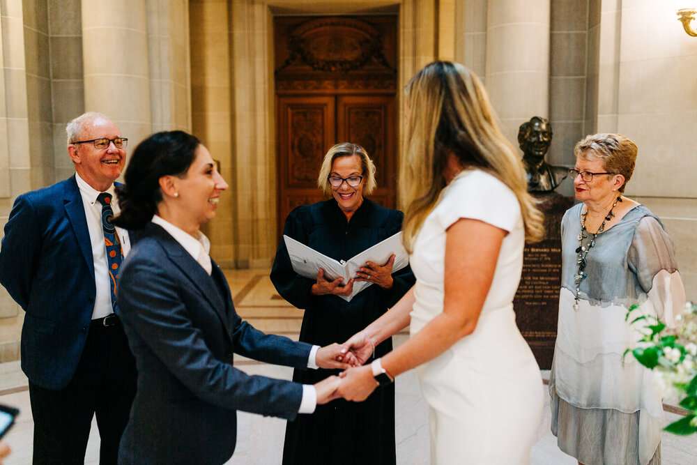 A San Francisco City Hall officiant smiles before beginning the civil ceremony