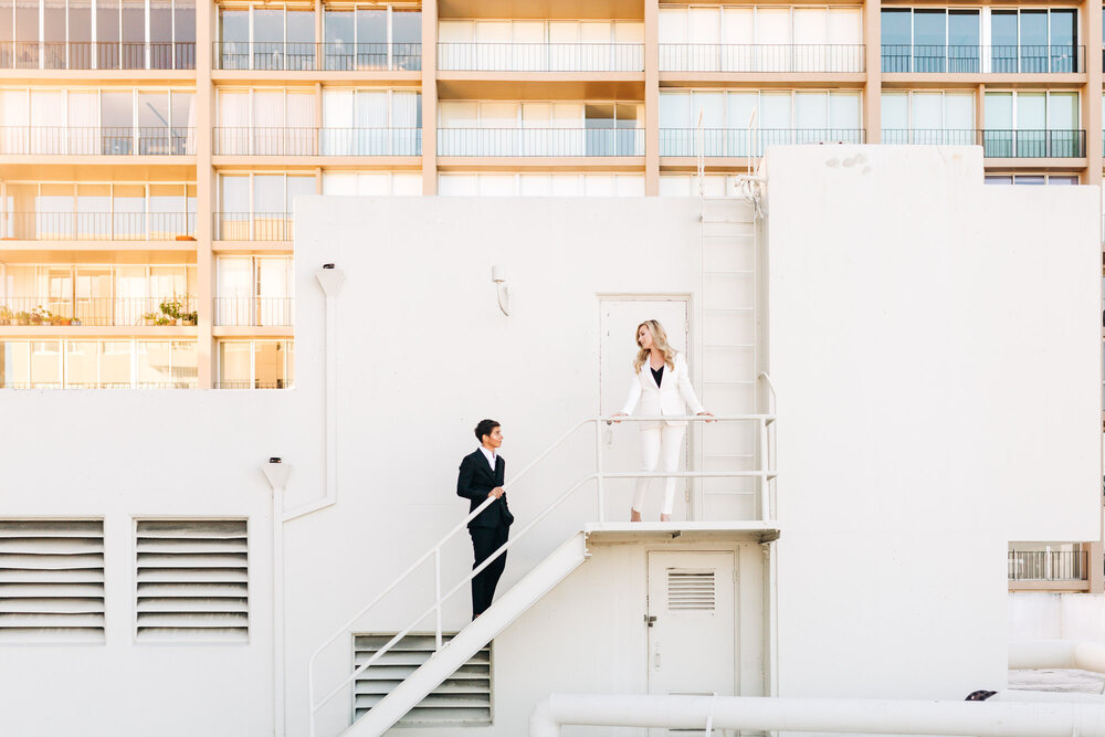 Elopement photo of two brides in tuxedos during for their San Francisco Embarcadero elopement 