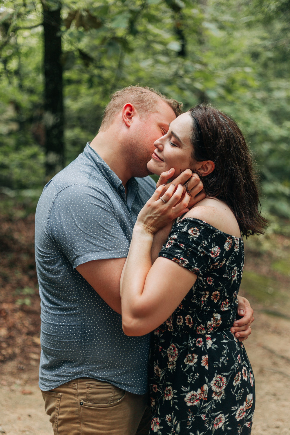 Couple wearing mixed patterns at their couples session in the woods.