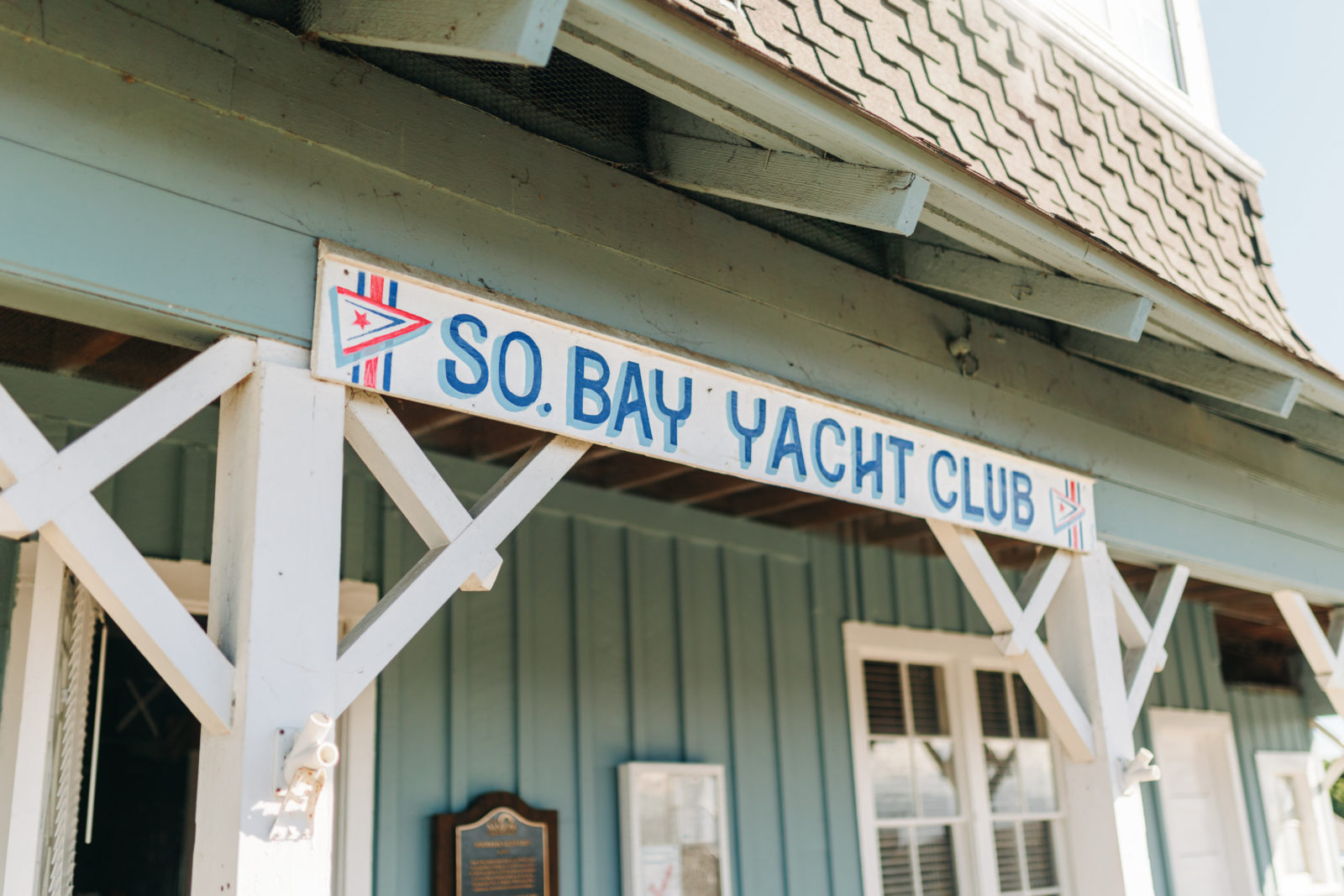 Photo of front of Yacht Club signage on a clear sunny day