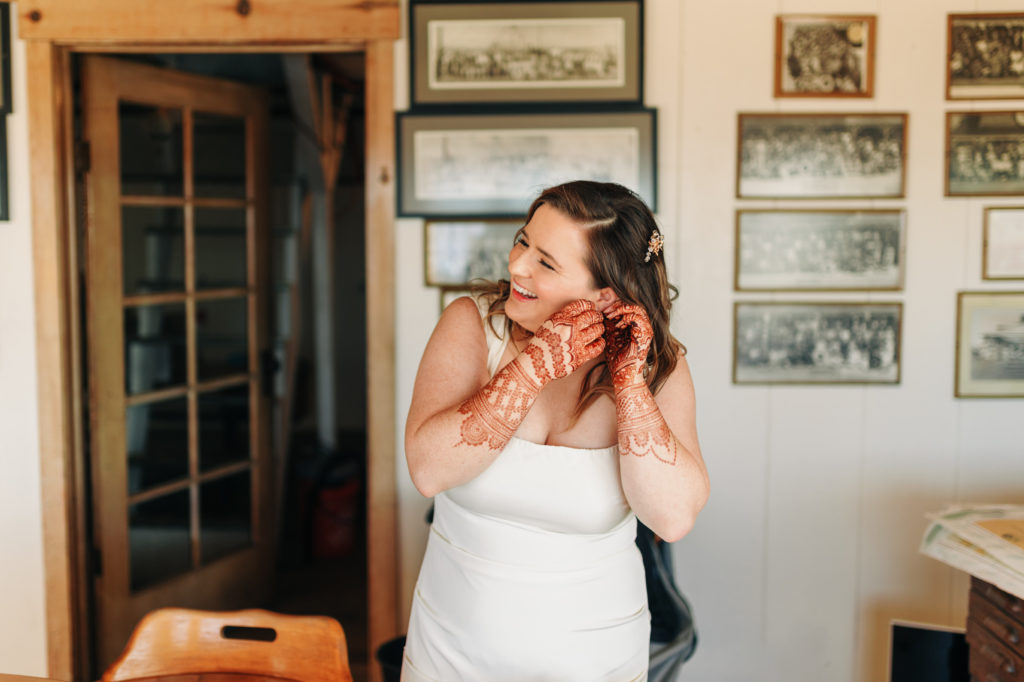 documentary style photography of bride getting ready with bridesmaid at a yacht club venue