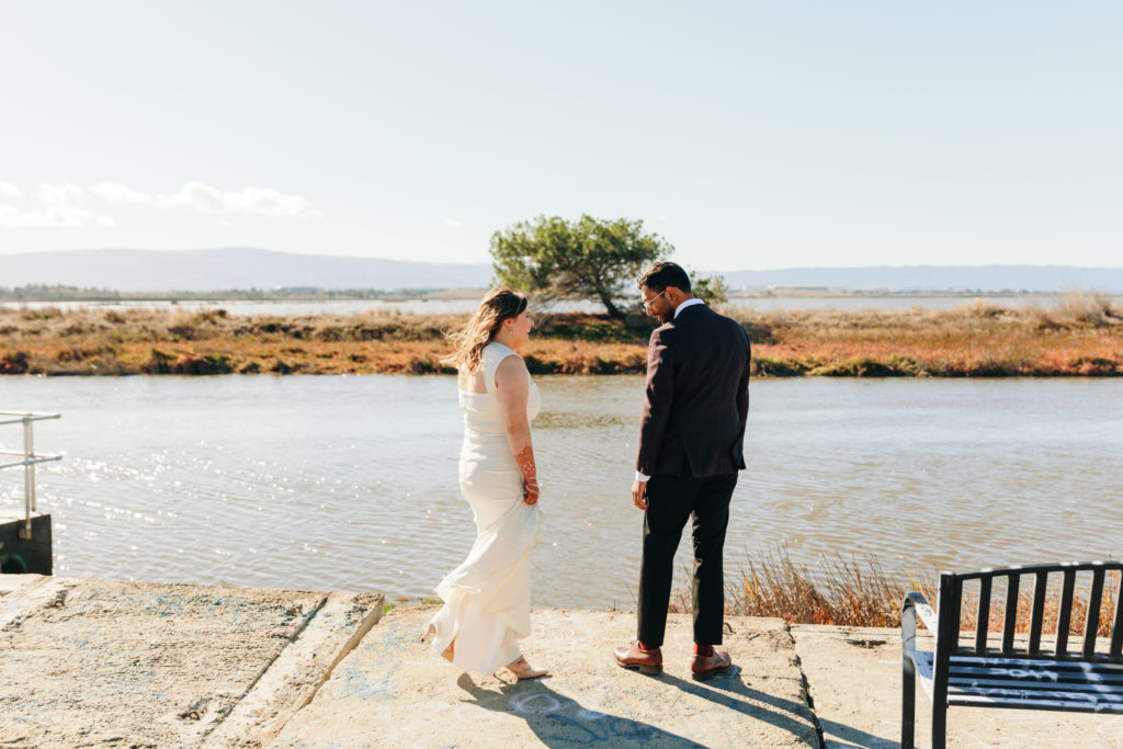 documentary style photography of couple sharing a first look overlooking the water at a yacht club venue