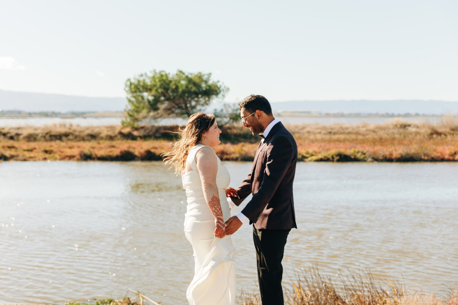 documentary style photography of couple sharing a first look overlooking the water at a yacht club venue