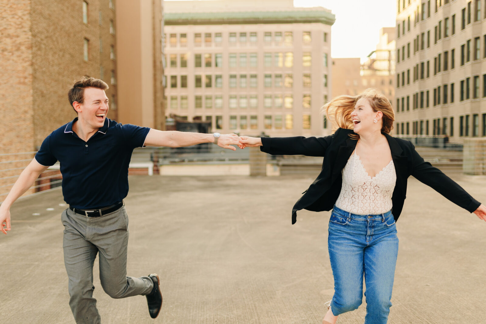 A playful couple running during their downtown engagement session in Memphis