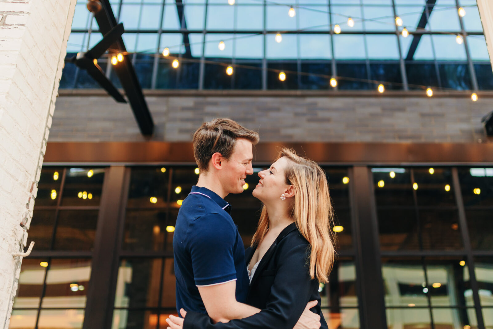 Engagement couple standing along a downtown Memphis street with urban background