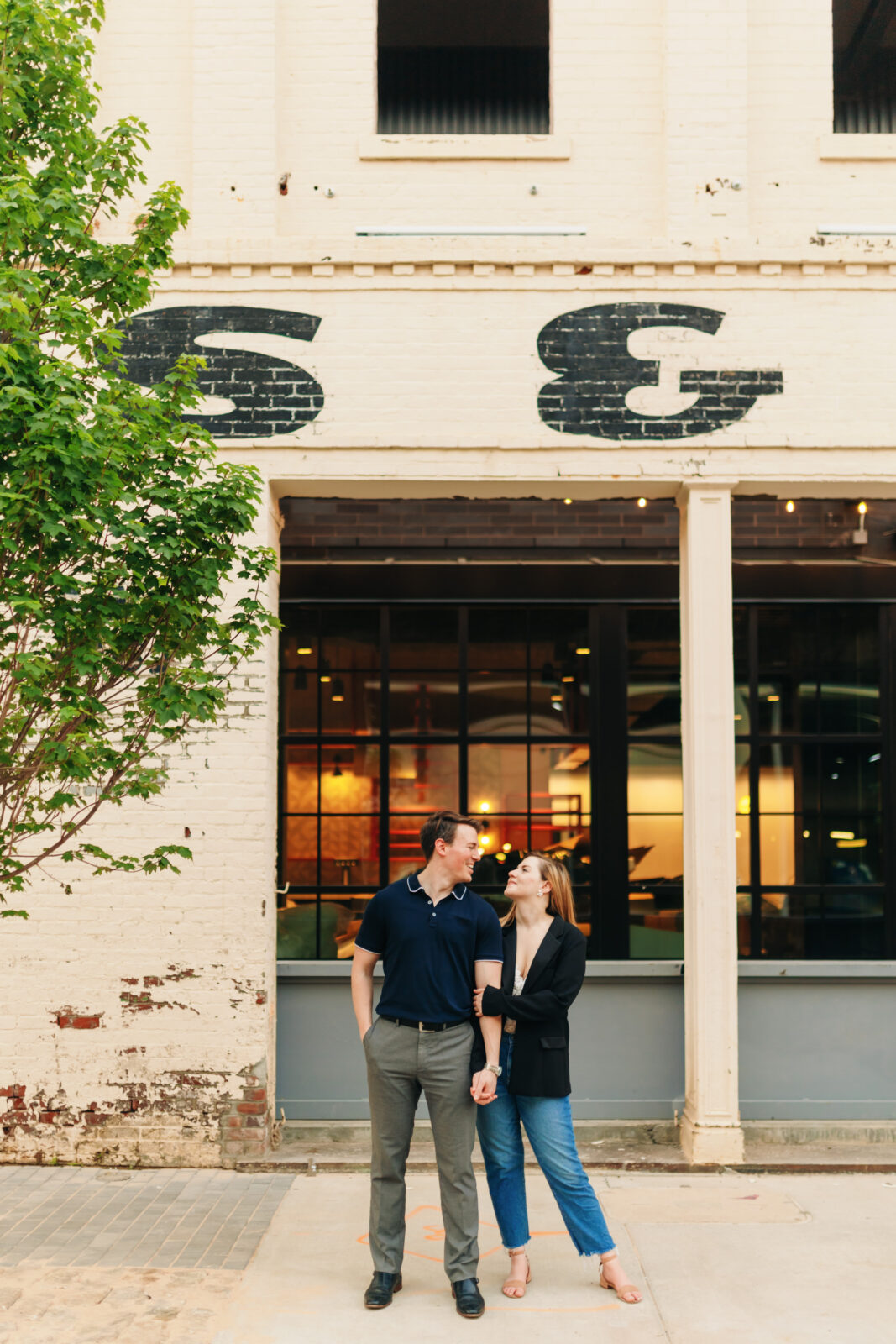 Engagement couple standing along a downtown Memphis street with urban background