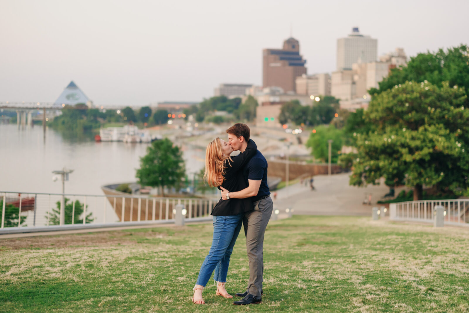 Engaged couple running along Beale Street Landing in downtown Memphis